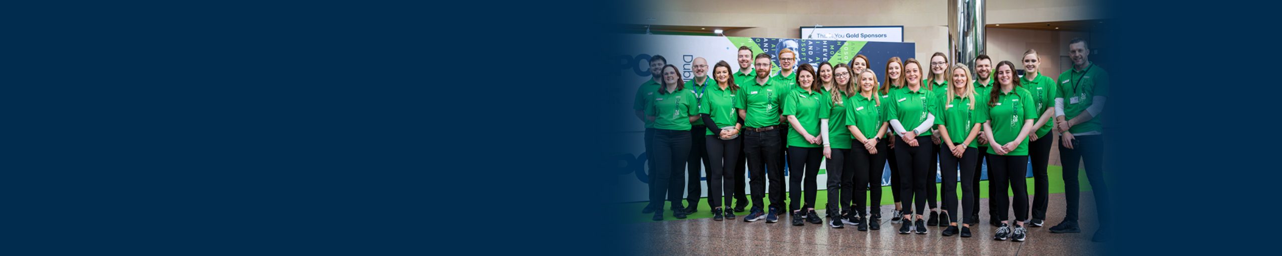 ESPC Dublin25 team posing for a group photo in green polo shirts
