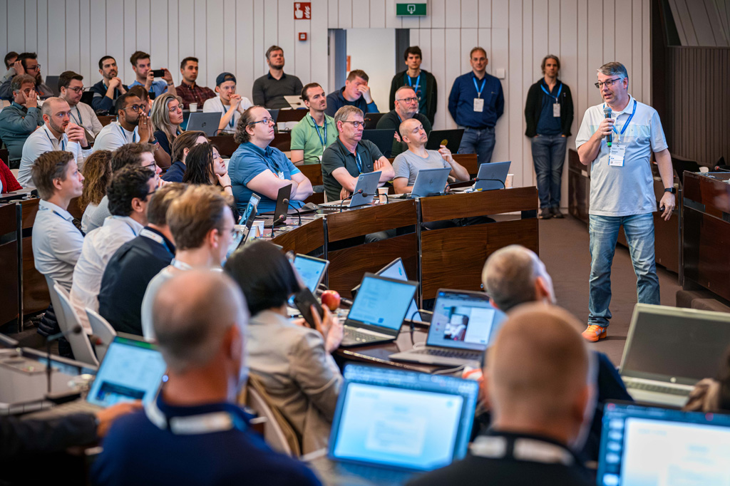 speaker on a mic addresses a full room during a tutorial