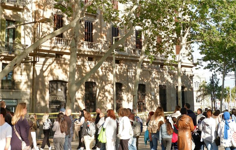 Explore the City Along La Rambla Group of people and a building