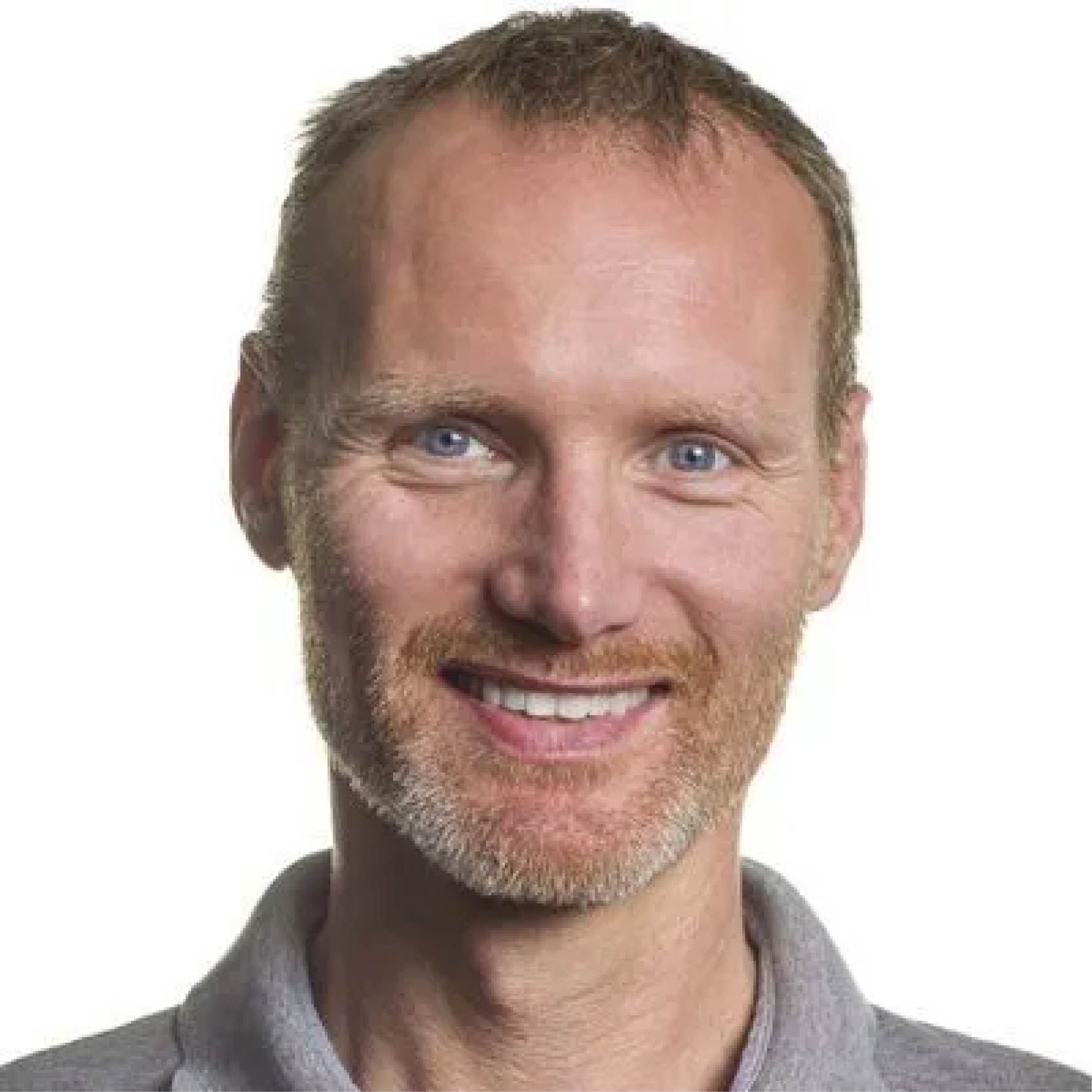 A person wearing a light shirt with a collar is shown from the shoulders upward against a plain background.