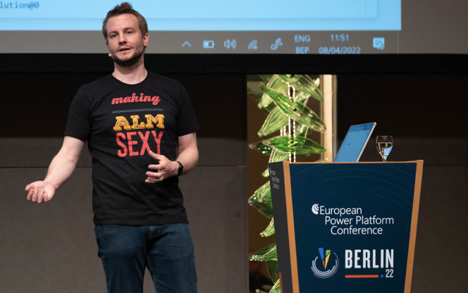 speaker standing at a lectern addressing a room during the european power platform conference in berlin 2022