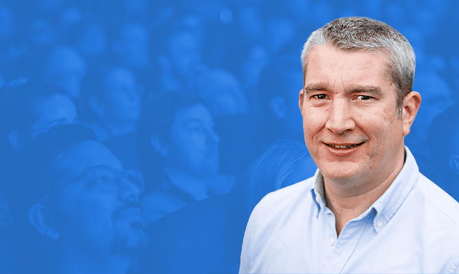 EPPC sponsor Bertie Stevenson smiles for the camera over a background of a sitting audience