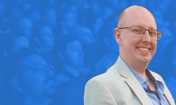 EPPC sponsor Matt Collins Jones smiles for the camera over a background of a sitting audience