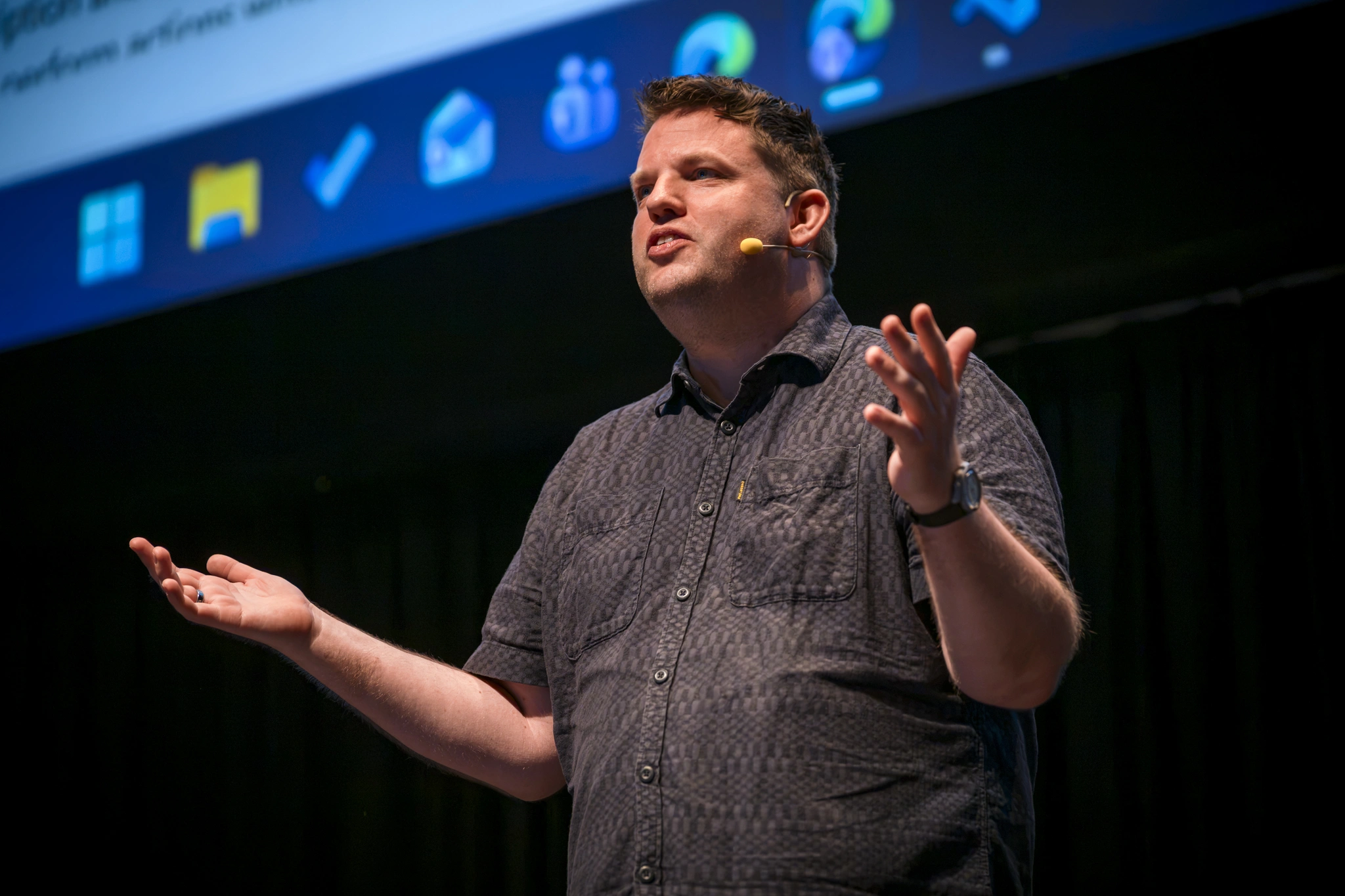 Daniel Laskewitz speaking on stage infront of screen