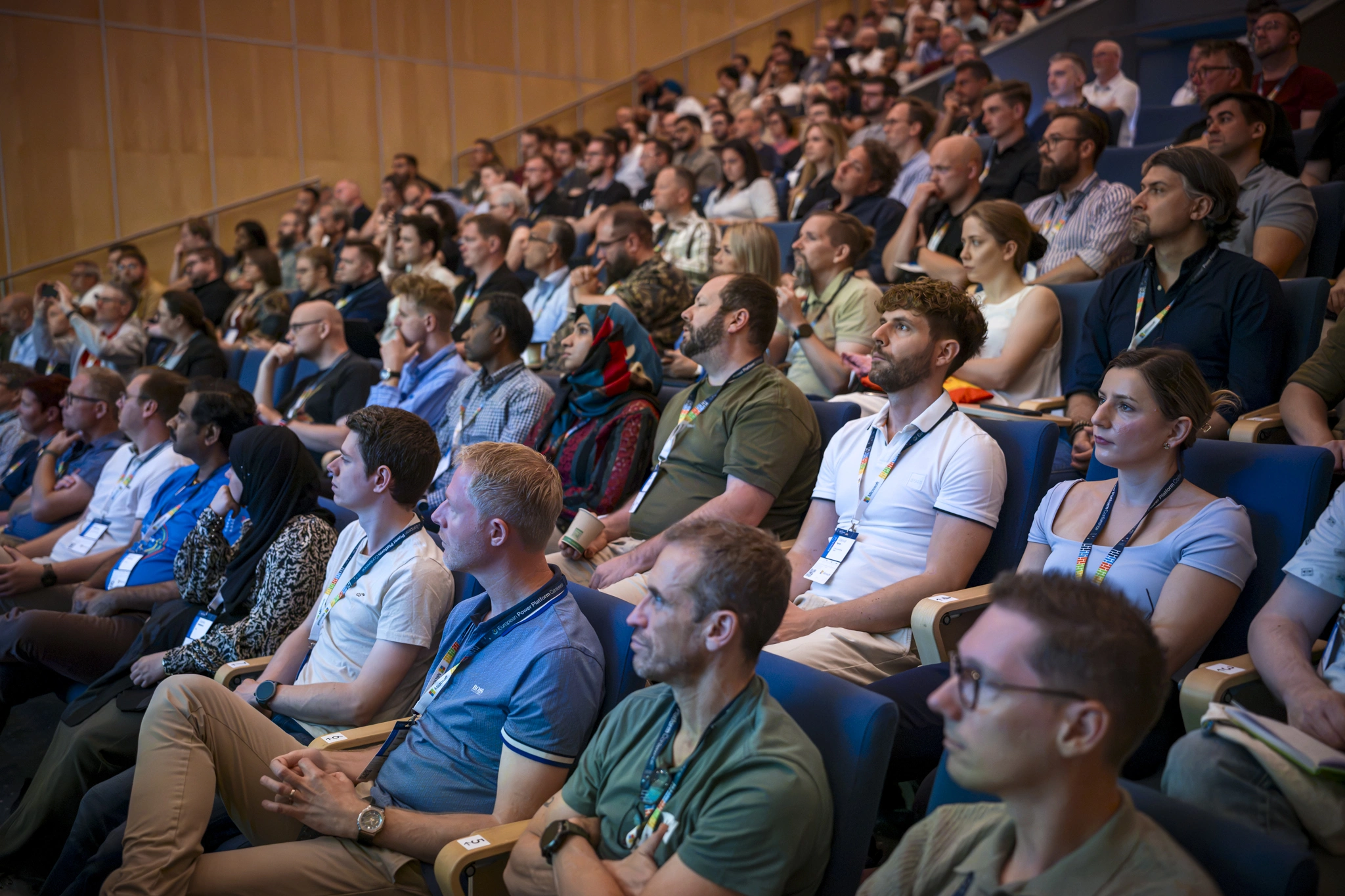 Large audience of attendees listening to a session