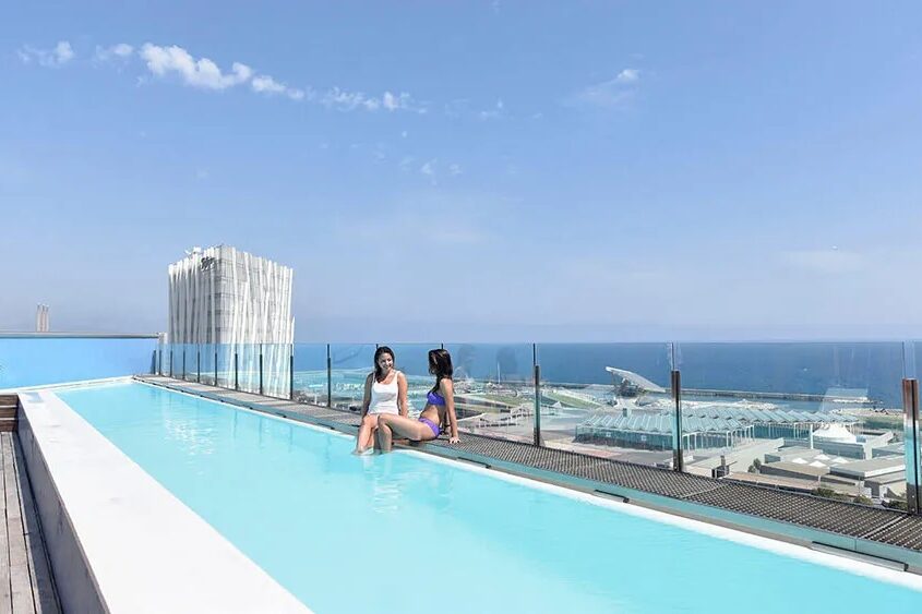 Two women relaxing in the pool at Hotel Barcelona Princess