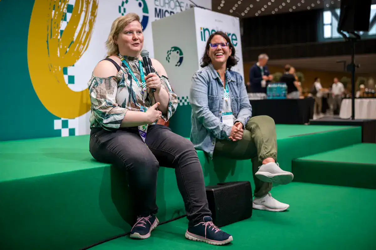 Two speakers sat on the Inspire Stage chatting